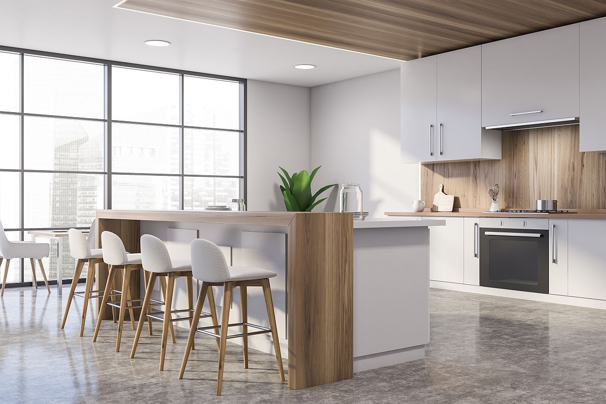 White and wooden kitchen corner with bar and table